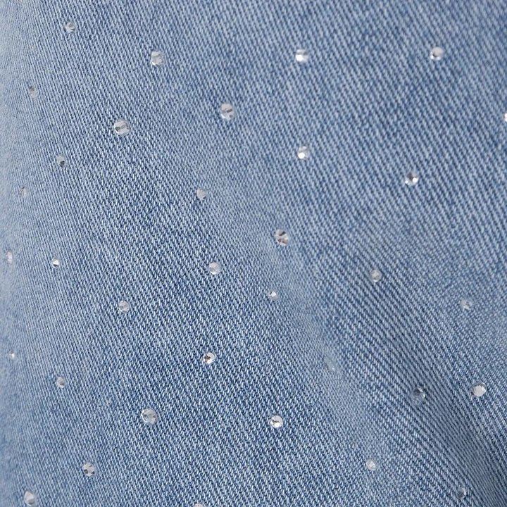 Jean taille haute orné de strass et boutonné sur le côté