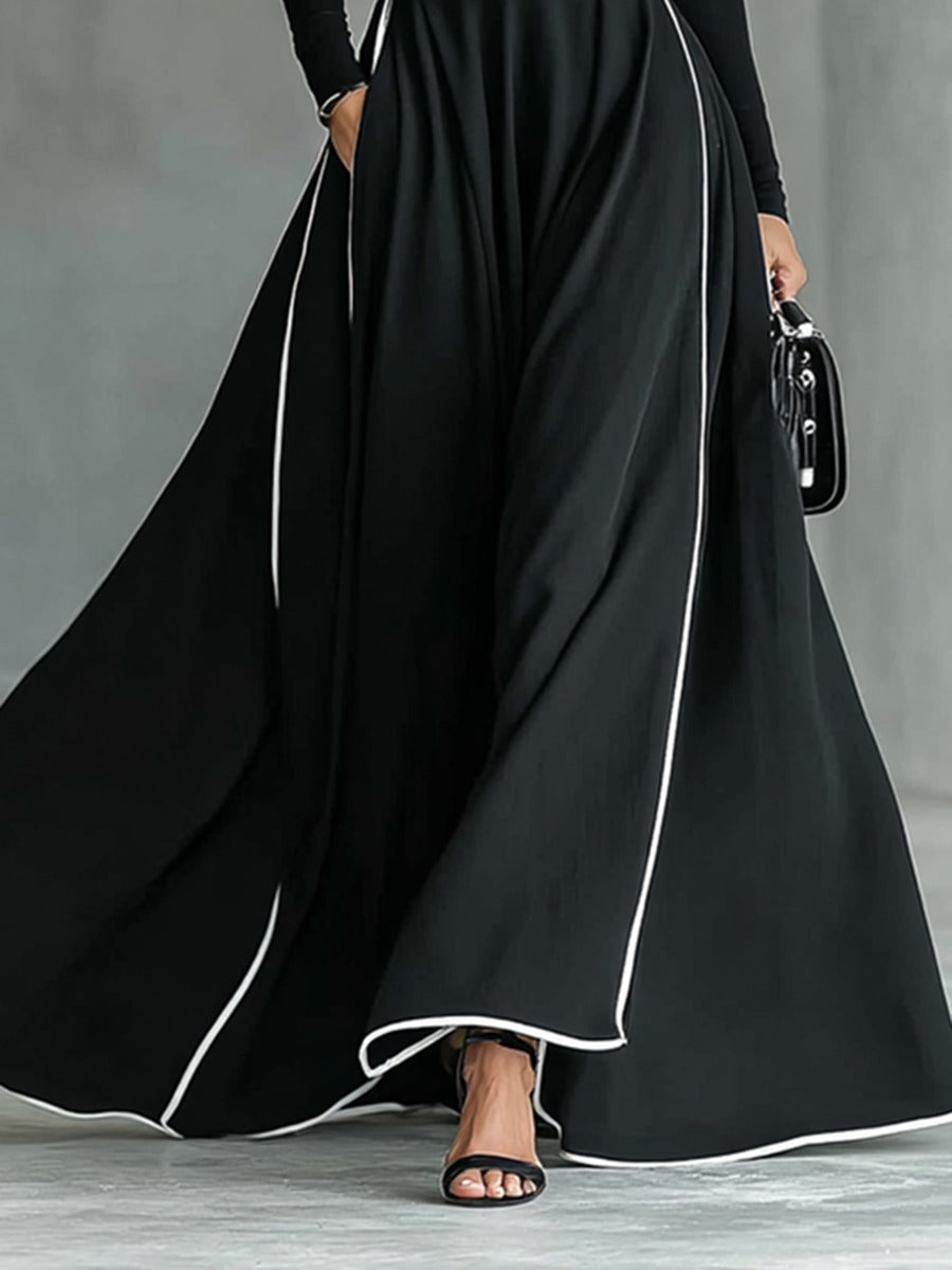 Robe longue noire col montant manches longues ceinturée avec surpiqûres