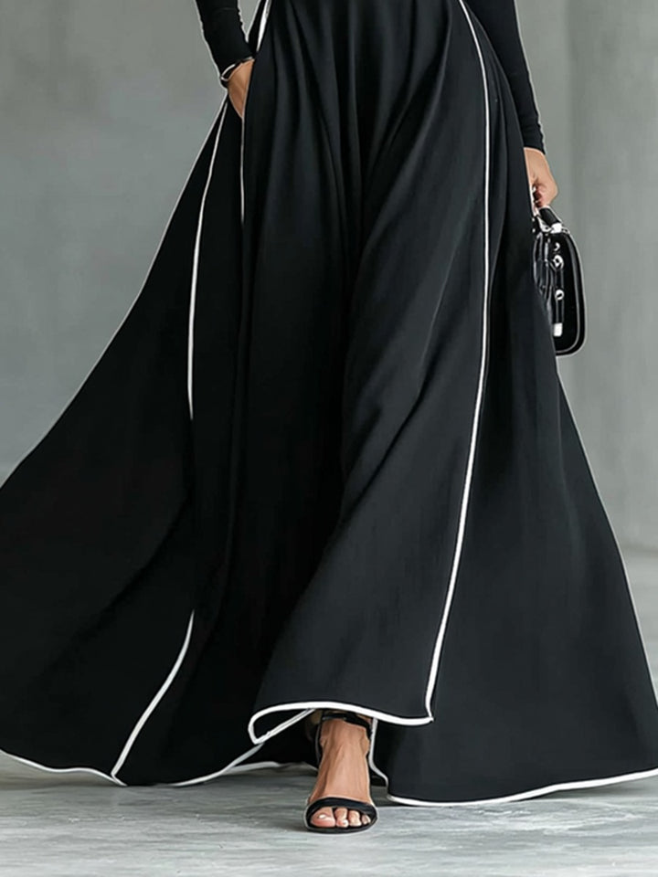 Robe longue noire col montant manches longues ceinturée avec surpiqûres